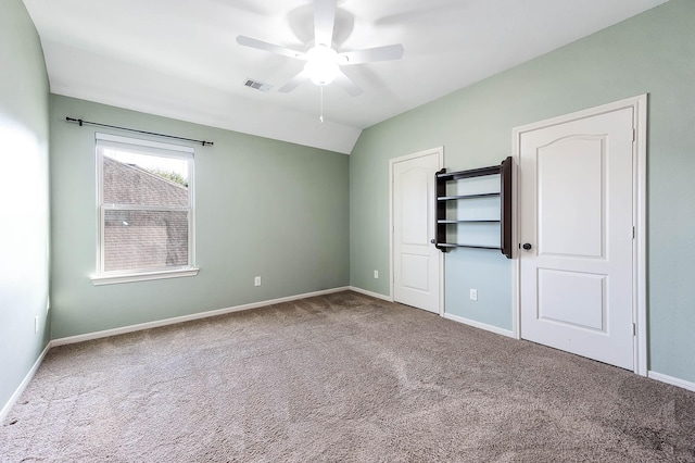 unfurnished bedroom featuring vaulted ceiling, ceiling fan, and carpet floors