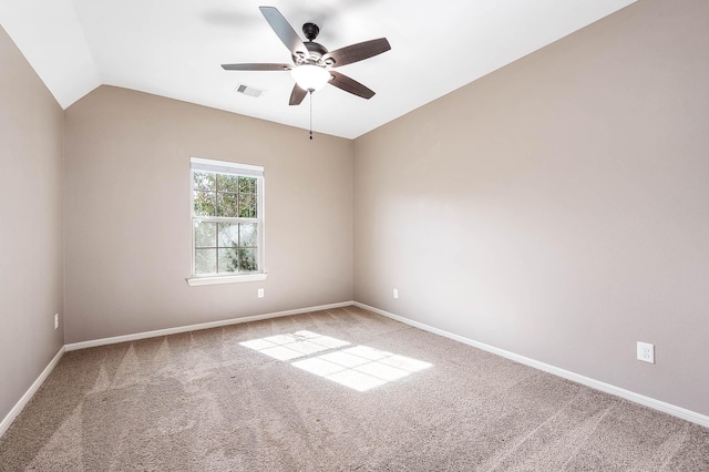 carpeted empty room featuring ceiling fan and vaulted ceiling