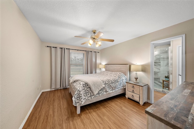 bedroom featuring ceiling fan, light wood-type flooring, and a textured ceiling