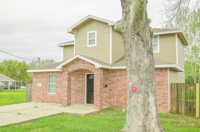 view of property with a front lawn and a patio