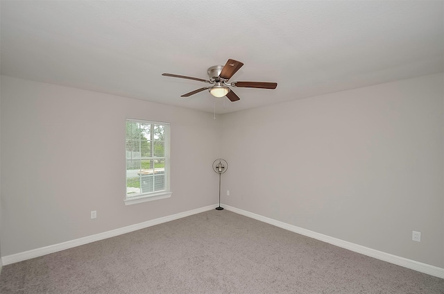 spare room featuring ceiling fan and carpet