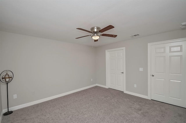 unfurnished bedroom with ceiling fan and light colored carpet