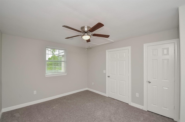 unfurnished bedroom with ceiling fan and carpet