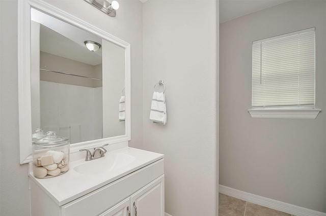 bathroom featuring walk in shower, tile patterned flooring, and vanity