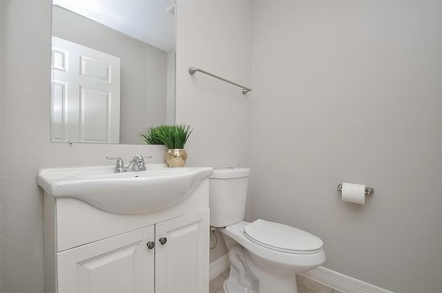 bathroom featuring toilet, vanity, and tile patterned floors