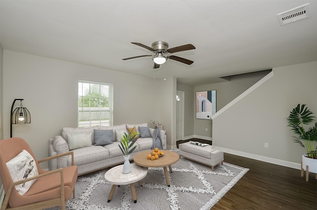 living room with dark hardwood / wood-style flooring and ceiling fan