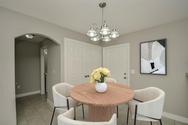 dining space with a notable chandelier and light tile patterned floors