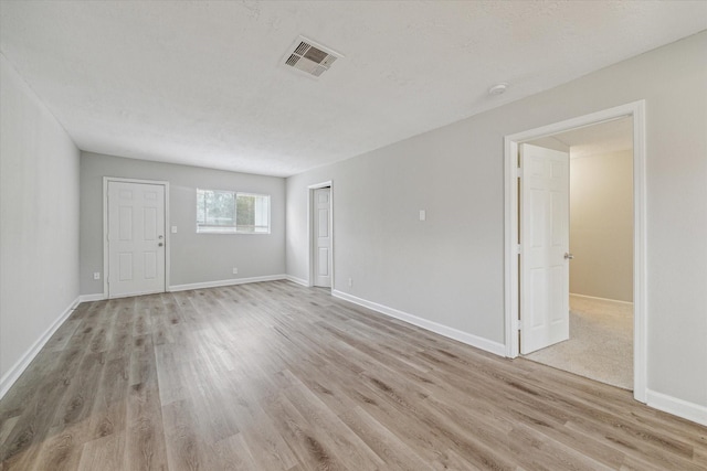 unfurnished room with light hardwood / wood-style floors