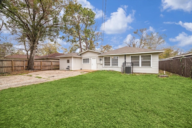 rear view of house featuring a lawn