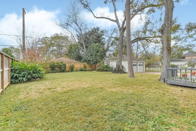 view of yard with a deck, an outdoor structure, and a garage