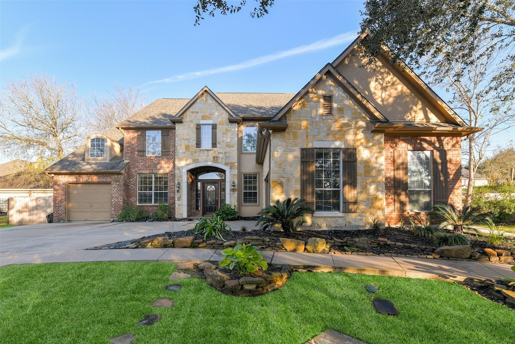 view of front of property featuring a garage and a front lawn