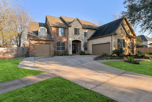 view of front of property featuring a front lawn and a garage