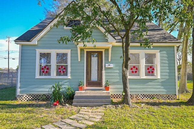 bungalow-style house with a front yard