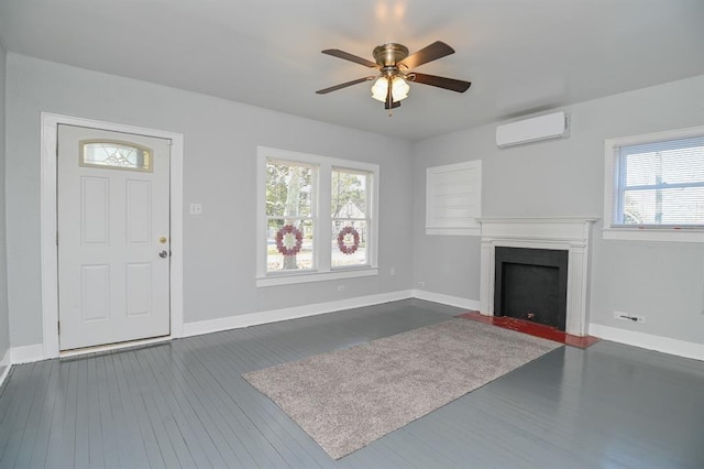 unfurnished living room featuring ceiling fan, dark hardwood / wood-style flooring, and a wall mounted AC