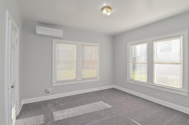 carpeted spare room featuring a wall mounted air conditioner