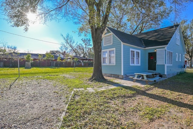 view of side of property with a yard and a patio area