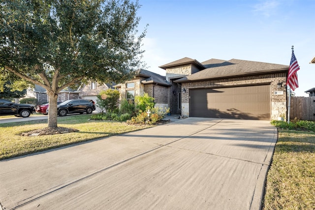 view of front of home featuring a garage and a front lawn