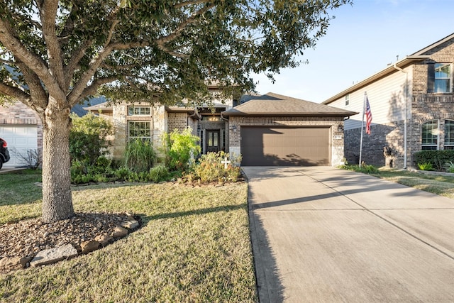 view of front of house with a front yard and a garage