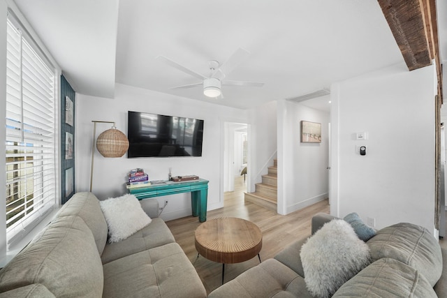 living room with light wood-type flooring and ceiling fan