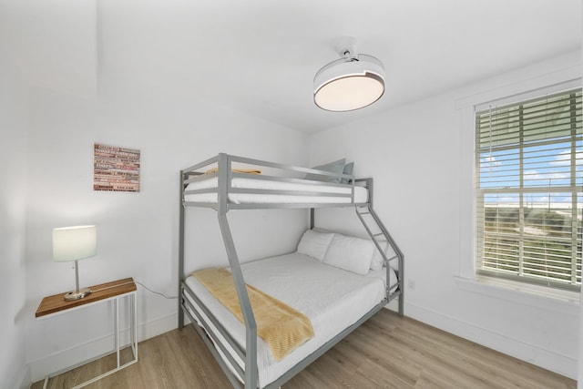 bedroom featuring light wood-type flooring and multiple windows