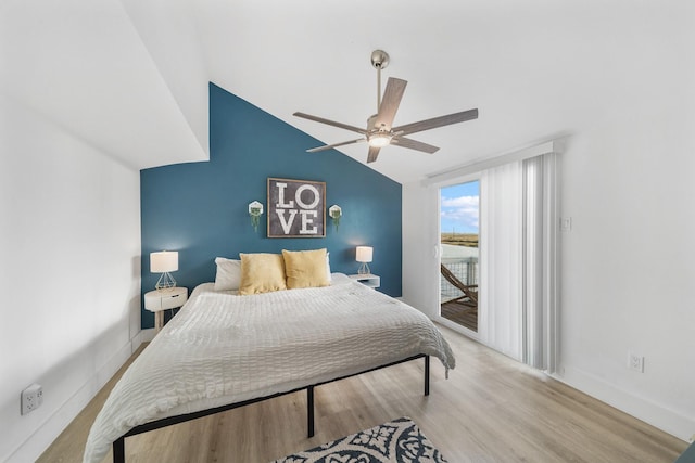 bedroom featuring ceiling fan, access to exterior, light wood-type flooring, and vaulted ceiling