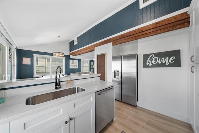 kitchen featuring sink, white cabinetry, stainless steel appliances, and light hardwood / wood-style flooring