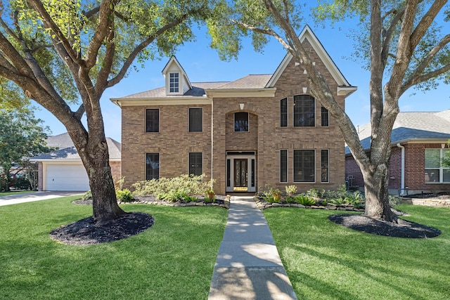 view of front of home featuring a garage and a front lawn