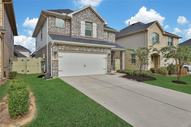 view of front of home featuring a front yard and a garage