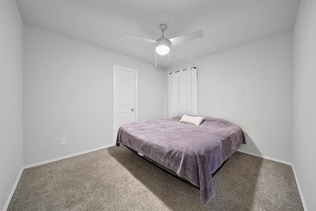 bedroom featuring dark carpet and ceiling fan