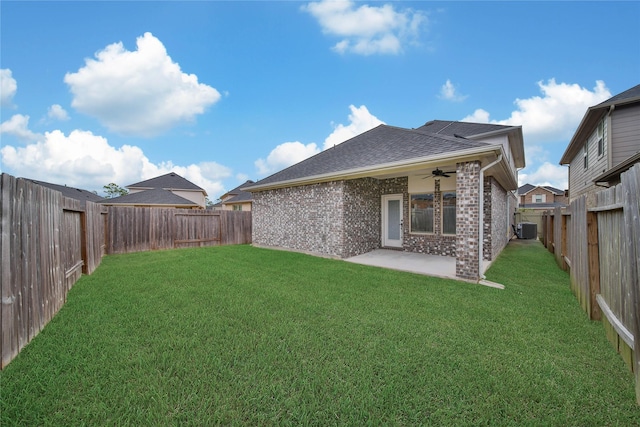 rear view of property with a lawn, cooling unit, a patio area, and ceiling fan