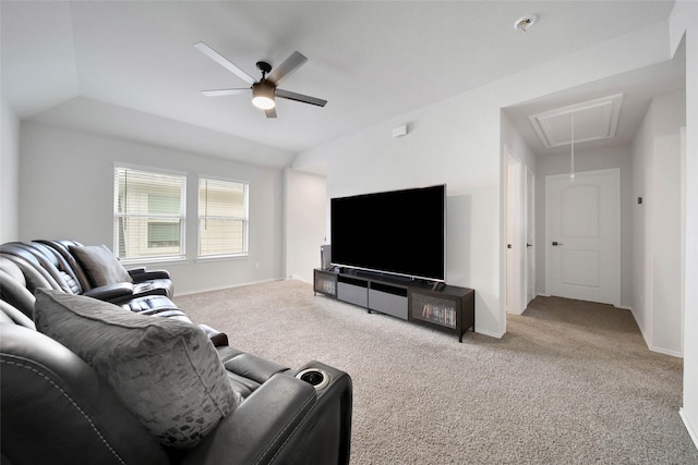 living room featuring ceiling fan, vaulted ceiling, and light colored carpet