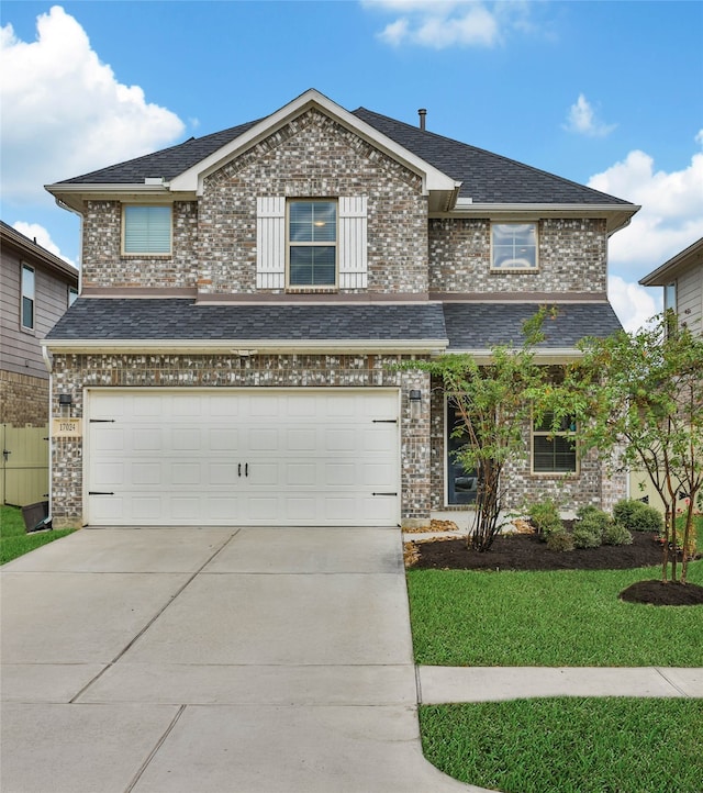 view of front facade featuring a front yard and a garage