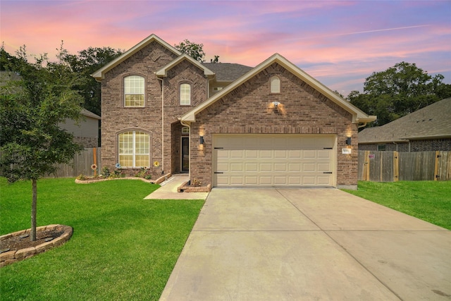 view of front of property with a garage and a yard