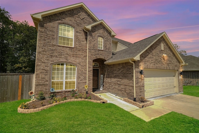 view of front of house with a garage and a lawn