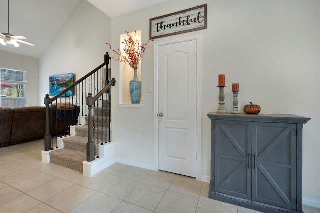 tiled entrance foyer featuring ceiling fan and lofted ceiling