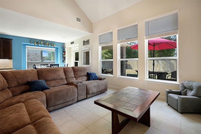 tiled living room with a wealth of natural light and lofted ceiling