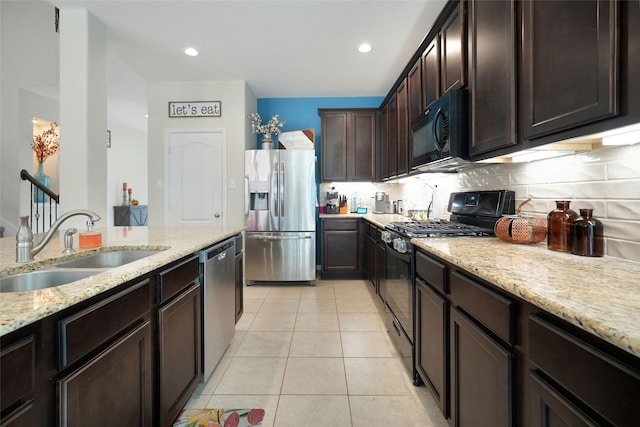 kitchen featuring dark brown cabinetry, light stone countertops, sink, light tile patterned floors, and black appliances