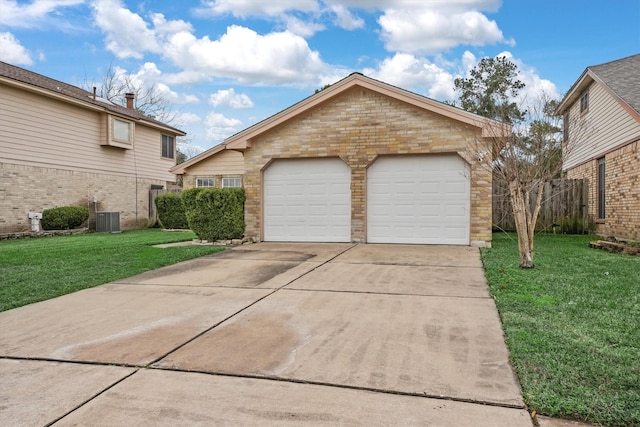 exterior space with a garage, a front lawn, an outdoor structure, and central air condition unit