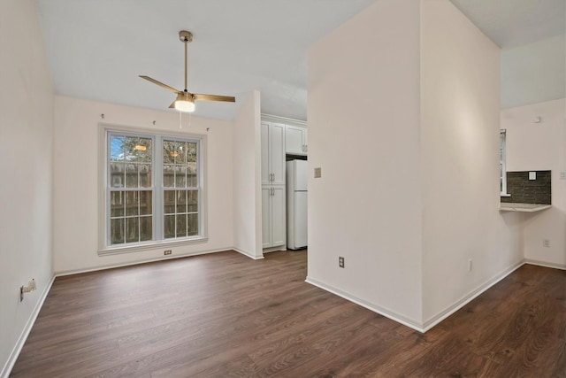 unfurnished living room with ceiling fan and dark hardwood / wood-style flooring