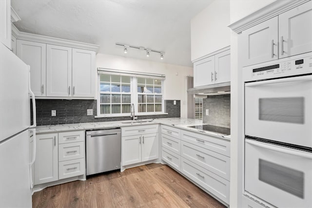 kitchen featuring white cabinets, white appliances, and sink