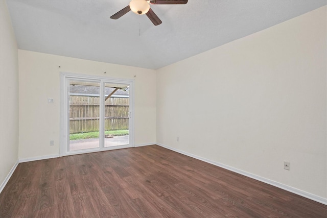 empty room with dark hardwood / wood-style floors and ceiling fan