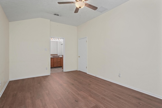 spare room featuring hardwood / wood-style flooring, vaulted ceiling, and ceiling fan