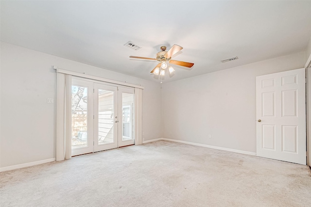 carpeted spare room featuring ceiling fan