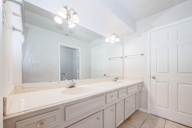 bathroom with tile patterned flooring and vanity