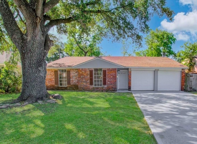 single story home with a front yard and a garage