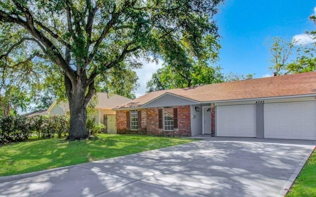 ranch-style home with a garage and a front yard