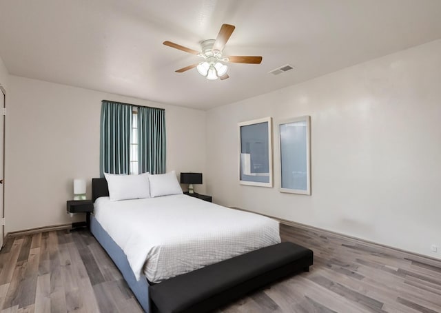 bedroom with ceiling fan and light hardwood / wood-style flooring