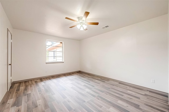 spare room featuring light wood-type flooring and ceiling fan