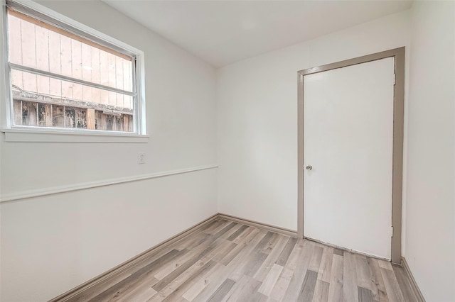 empty room with light hardwood / wood-style flooring