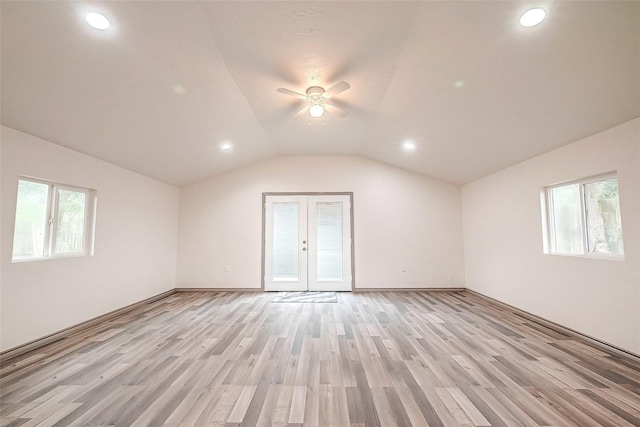 interior space with ceiling fan, vaulted ceiling, light hardwood / wood-style floors, and french doors